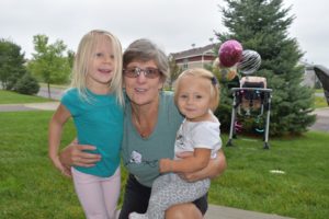 Invictus member posing with her two young granddaughters.