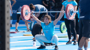 Female athlete snatching in competition.