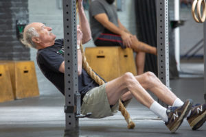 82-year-old athlete does a customized version of rope climbs from the supine position to standing.