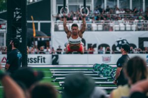 Female athlete doing ring muscle-ups at the 2018 CrossFit Games.