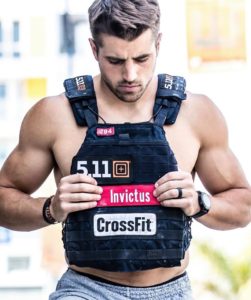 Male Invictus athlete wearing a weight vest instead of a shirt.