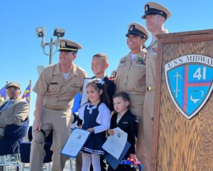 Leslie and her family on the podium at her Navy retirement ceremony.