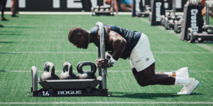 Chandler Smith pushes a sled at the 2023 CrossFit Games in Event 4.