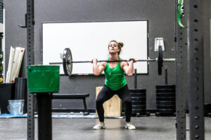 Female athlete standing up a clean.
