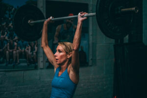 female athlete with bent elbows in the jerk