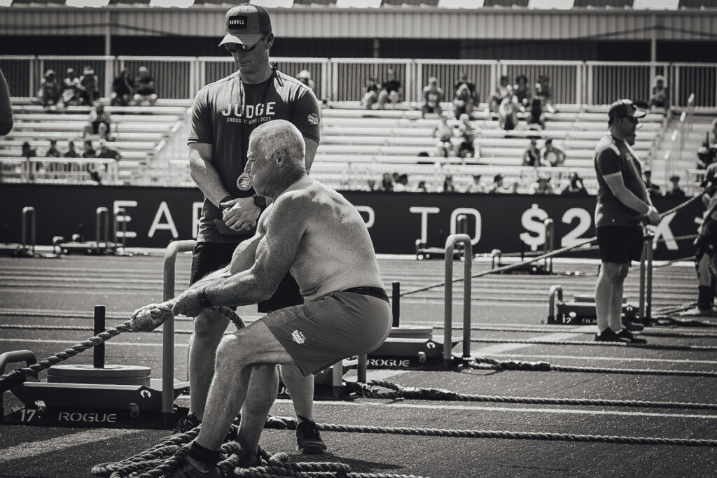 Invictus Masters Athlete, John Mariotti, doing a sled pull at the 2023 CrossFit Games.