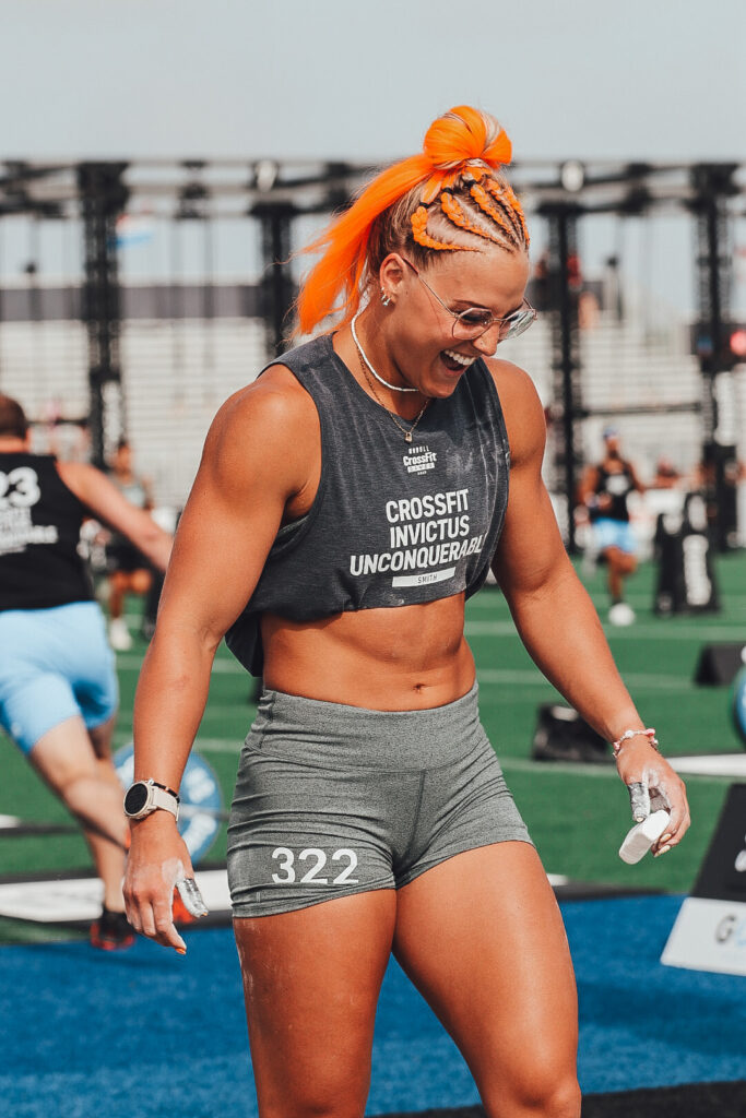 Jessi Smith laughing at the 2023 CrossFit Games with bright orange hair. 
